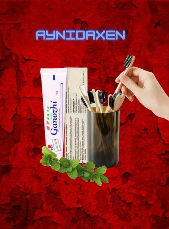 Pasta dental Ganozhi DXN, caja sellada y pasta suelta con adornos de flores y un pomo lleno de cepillo de diente de bambú.