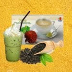 DXN Oocha en la caja más un vaso de té, con hojas de te Oolong.