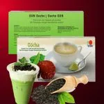 DXN Oocha en la caja más un vaso de té, con hojas de te Oolong.